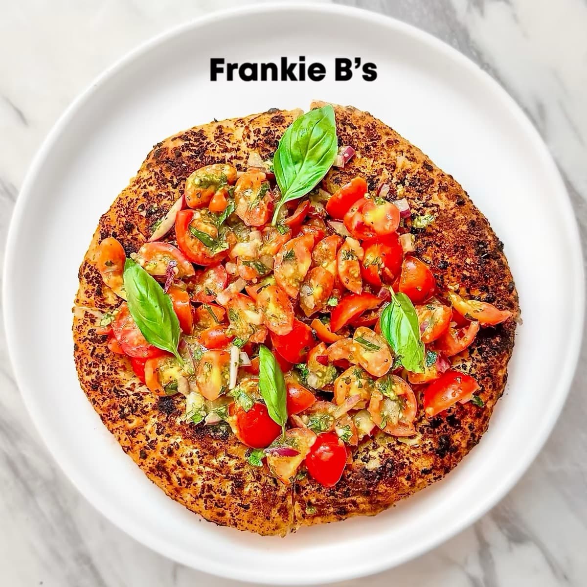 Tomato Bruschetta Crust at Frankie B's – Wood-fired garlic and herb crust with cherry tomato bruschetta