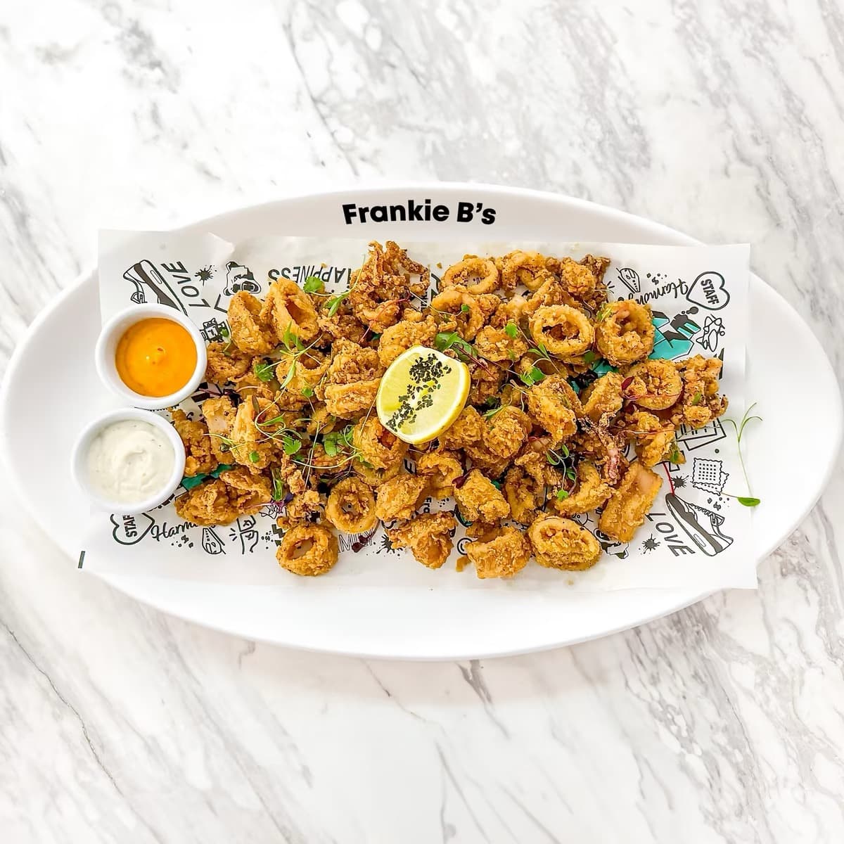 Salt and Pepper Calamari at Frankie B's – Crispy fried tempura calamari with dipping sauces