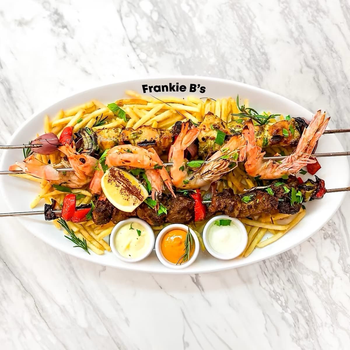 Triple Spiedino Combo at Frankie B's – Grilled lamb, chicken, and king prawn skewers with fries and dips