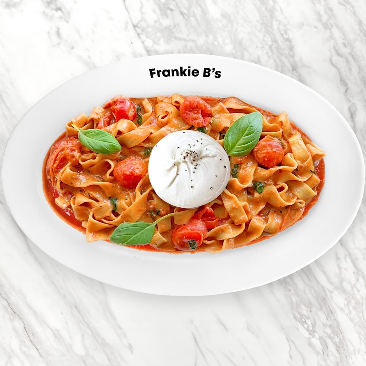 Pranzo fettuccine in creamy tomato pink sugo topped with burrata and fresh basil